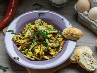 Scrambled egg with dried tomatoes and home baked goods