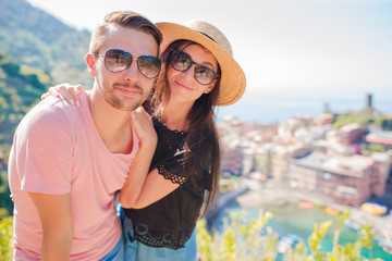 Naklejka premium Happy couple with view of the old coastal village, Cinque Terre national park, Liguria, Italy ,Europe