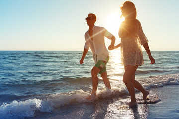 Happy young couple enjoying the sea