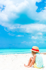 Fototapeta na wymiar Cute little girl in hat at beach during caribbean vacation