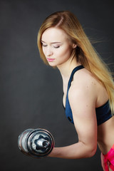 Fit woman lifting dumbbells weights