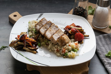 Pork medallions with grilled vegetables and vegetable couscous. Excellent food