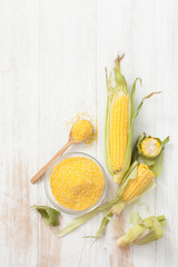 Corn grain and chopped corn on the cob on a white