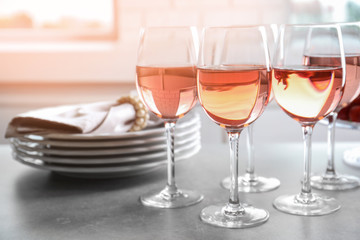 Glasses of strawberry wine on table