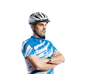 Mature man in sports t-shirt and helmet. Studio shot, isolated.