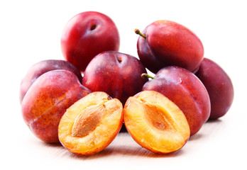 Composition with plums isolated on white background