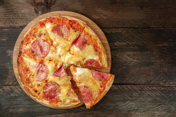Pepperoni pizza with slice cut off and place for text
