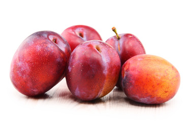 Composition with plums isolated on white background