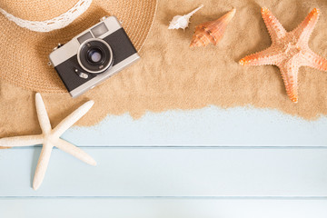 Film camera and sea shells on sand on blue background,summer concept top view © sorrapongs