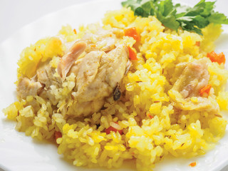 pilaf with meat on a white plate