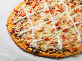 Homemade round classic russian pizza on a table