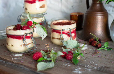 Tiramisu cake in glass jar with red raspberry