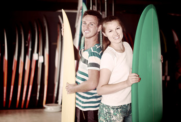 Portrait of couple is satisfied of choose surfboard