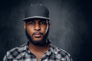 A man dressed in a fleece shirt and baseball cap.