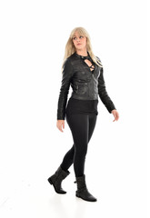 Fototapeta premium full length portrait of blonde girl wearing black leather outfit, standing pose on white background.