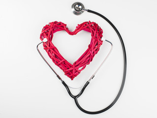 Close-up of creative composition made with big mockup heart and stethoscope on white background. Isolated.