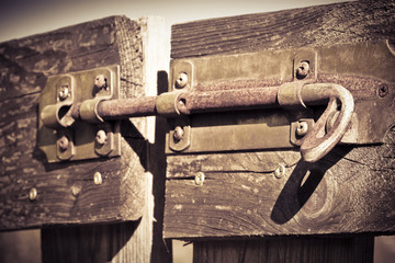 Closed wooden gate with bolt - concept image - toned image