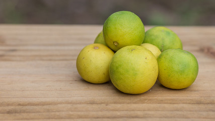 Fresh lemons on wooden background.