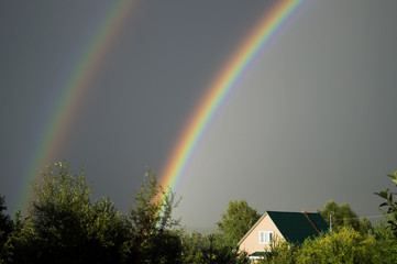 Two rainbows over the farm house.