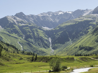 Alpine massif, beautiful Alpine canyon in Austria. Alpine Gastein Valley in summer. Mountains and pastures. Fresh air and healthy virgin nature. Excursional destination for hiking, vacation.