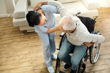 Nice elderly man using caregivers help
