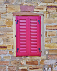 Fototapeta na wymiar red window, old stone wall house detail