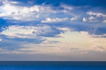 Obraz na płótnie Canvas Calm sea with cloudy sky in the background - concept image with copy space