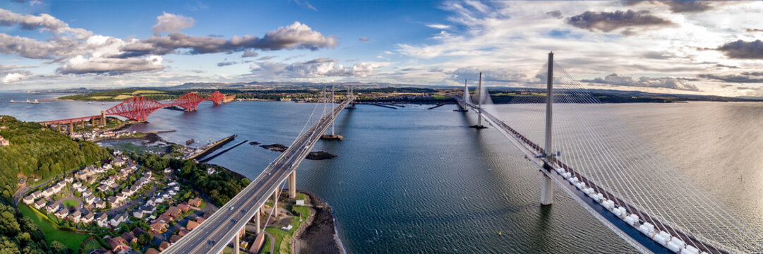 The new Queensferry Crossing bridge (on the right) over the Firth of Forth with the older Forth Road bridge (on the left) and with the iconic Forth Rail Bridge in the far left.