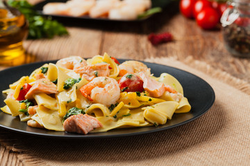 Traditional Italian fettuccini with salmon, shrimp and spinach.