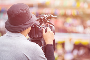 Obraz premium Cameraman using professional digital video camera. Outdoor setup and working
