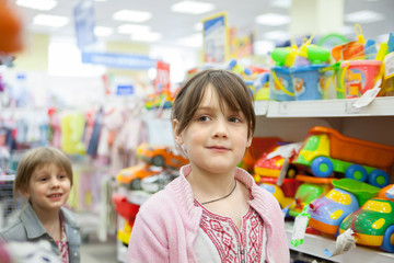 girl in   toy store choosing   toys