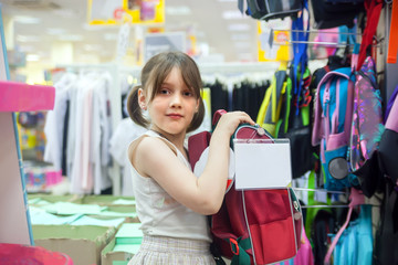  girl in   store choosing   briefcase