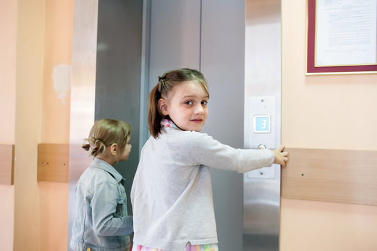  little girls causing   elevator in   high-rise building
