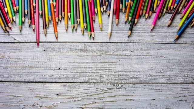 Timelapse of colored pencils on wood background. Stop motion animation.