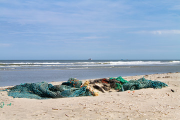 Fototapeta na wymiar Fishing nets washed up on the beach