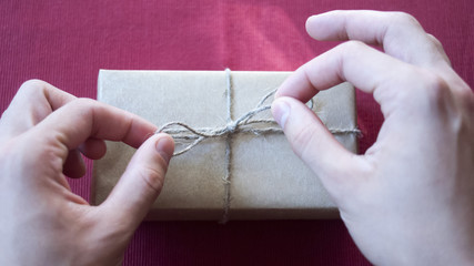 Fototapeta premium The man wraps gifts