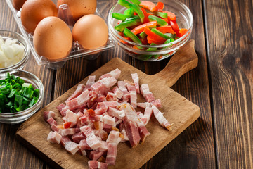 Ingredients for preparing omelette with bacon and vegetables