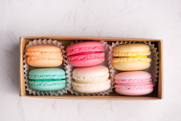 Sweet macarons. Different french cookies macaroons in a paper box.