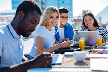 Female blonde student smiling into camera