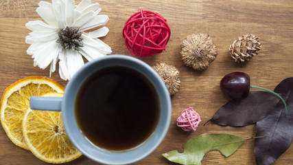 Coffee, fruit and flowers on a wooden table. The concept of the autumn morning.