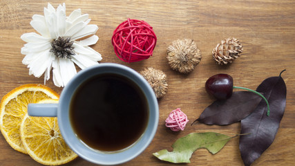 Coffee, fruit and flowers on a wooden table. The concept of the autumn morning.