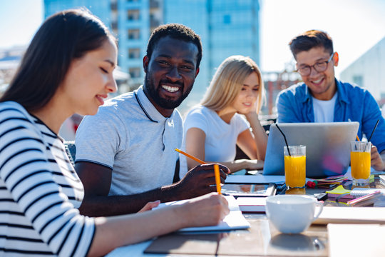 College students doing home assignment outdoors