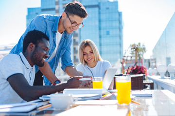 Cheerful students enjoying studying together