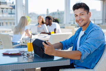 Relaxed freelancer working on tablet computer