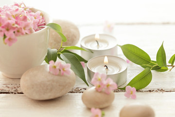 SPA still life with pebbles, flowers and aromatherapy candles