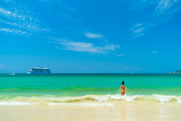 Fototapeta premium Woman walking on the beach