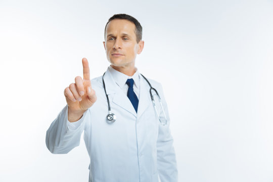 Cheerful Physician Touching Invisible Wall