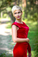 Fototapeta premium beautiful woman in red dress outdoors in summer