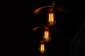 Retro light bulb hanging with dark space background for your decoration, concept of creativity