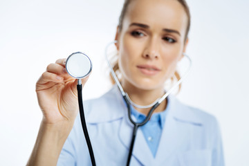 Close up of female medical professional using stethoscope